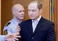 Breivik getting a pat on his shoulder by a colleague.
