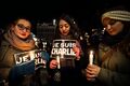 Women about to burn Je suis Charlie signs