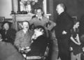 Hitler sharing a joke with friends. Possibly about Jews.