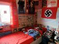 The edgemaster's stronghold. Note the swastika flag, not one, but two Joker posters and, my personal favorite, the roll of toilet paper on the bedside table.